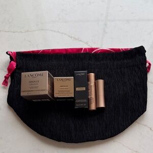 Lancôme Absolue skincare set with black pouch and rose-gold accents